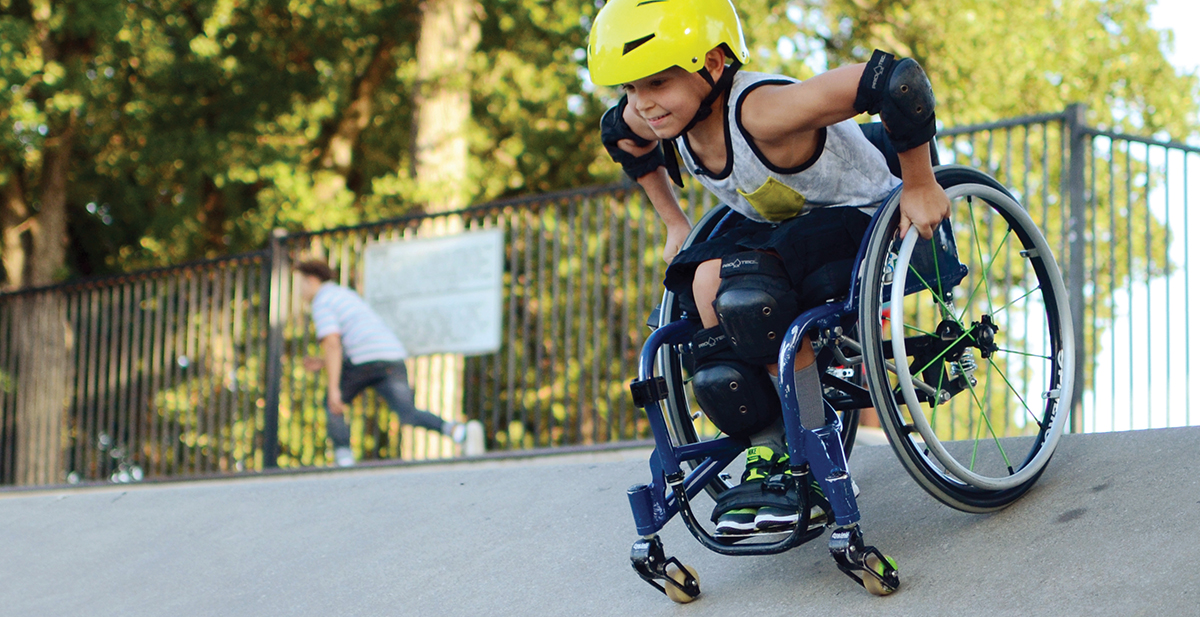 Patient in his wheelchair at a skate park.