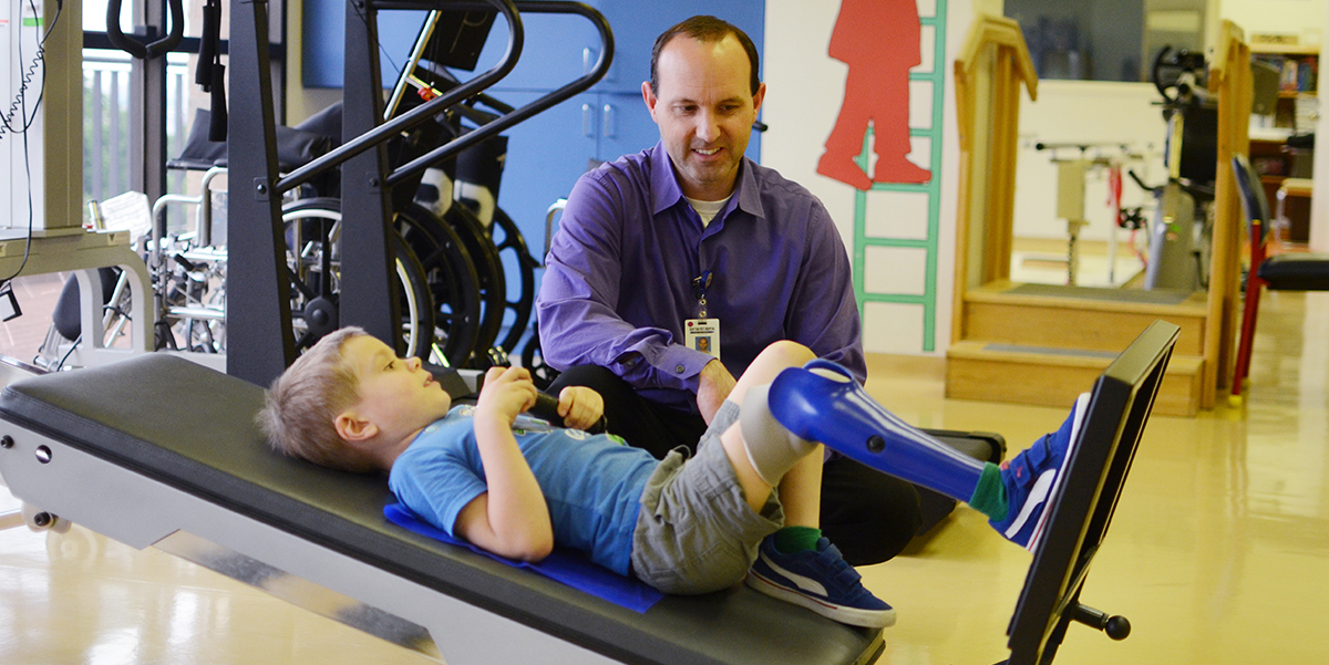 A physical therapist helps a patient during a therapy session.