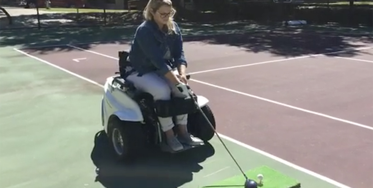 Recreational Therapist demonstrates using the Paragolfer.