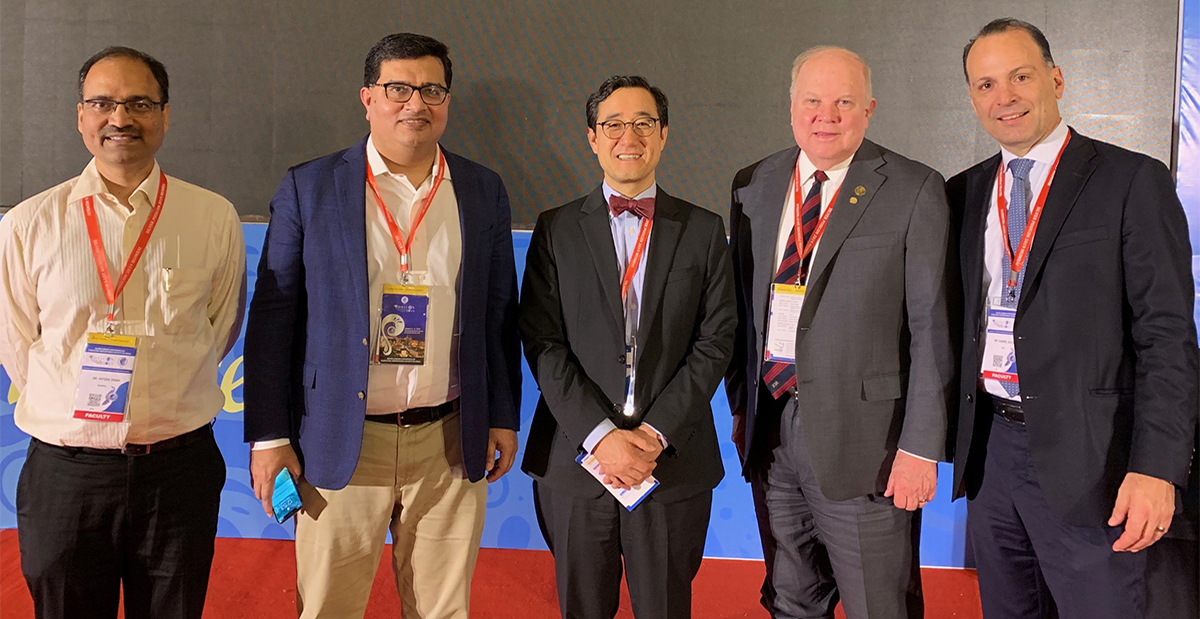 Drs. Kim and Sucato at POSI conference in India with other attendees.
