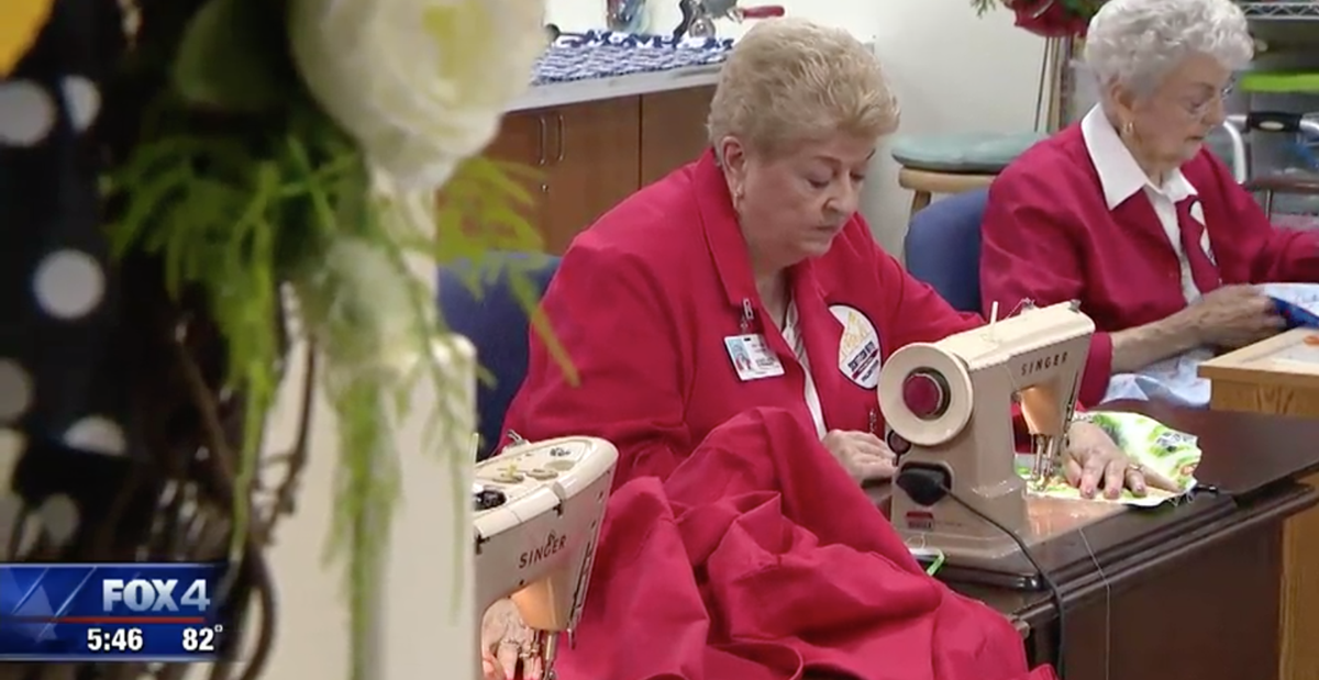 Volunteers sew bed sheets and gowns for patients