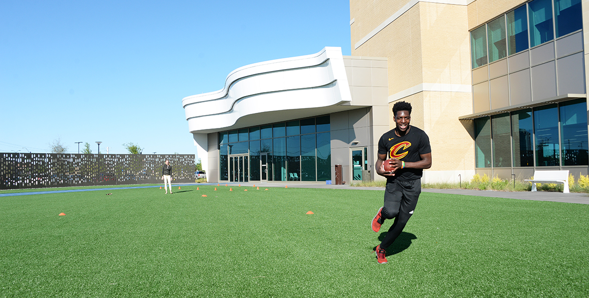 patient playing football at Frisco campus